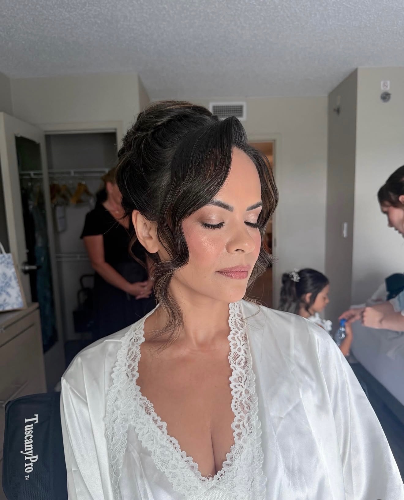 Bride with a soft romantic updo and glowing neutral bridal makeup