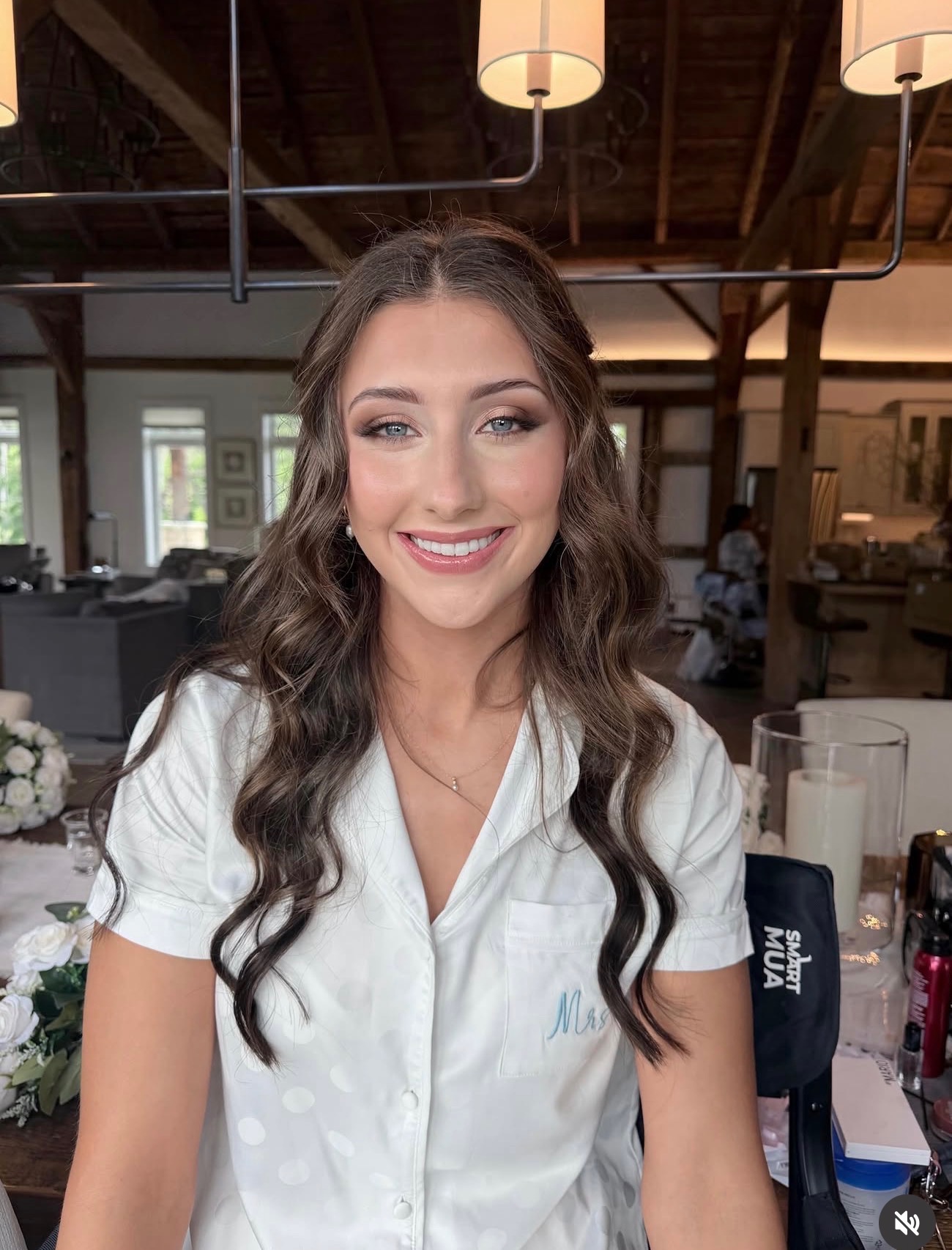 Bride in white pyjamas with long waves and soft glam bridal makeup